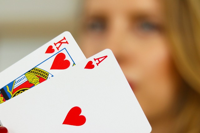 A close-up of cards being dealt on a casino table during a friendly game